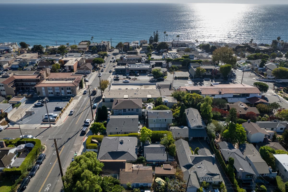Aerial view of a coastal neighborhood with homes and streets leading to the ocean